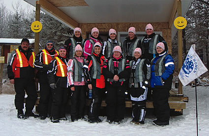 people gathered around in front of a cabin