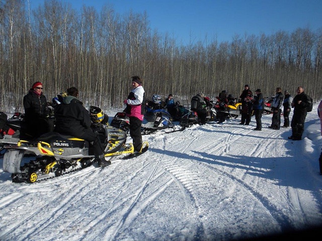 A group of sledders stopped along the trail for a break during the 2010 poker rally.