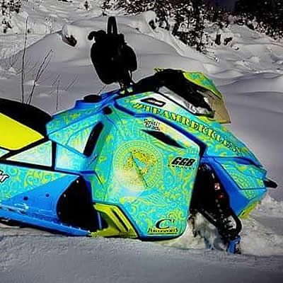 A green, blue and yellow sled wrap on a Ski-Doo. 