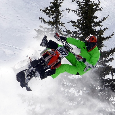 Reagan Sieg sending his Timbersled snow bike over a jump in the mountains. 