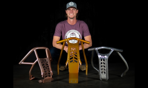 Dan Verot next to three of his snowmobile bumpers