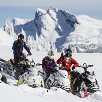3 riders sitting on their sleds in a mountain bowl near Revelstoke, B.C.  