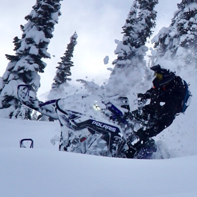 Rijel Hunley crashing through powdery snow on his sled