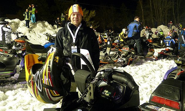 Man standing by his sled in the parade. 