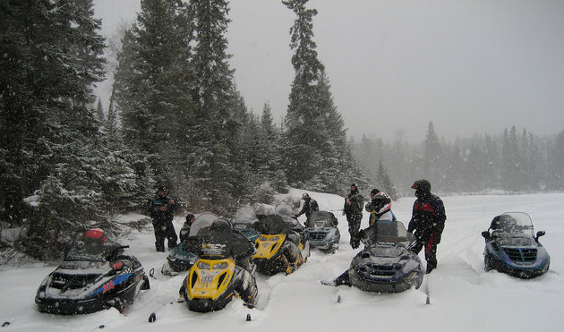 Snowmobilers explore the forest trails near Lac du Bonnet.