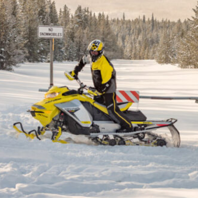 person in yellow on a yellow sled