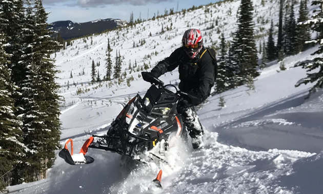 Snowmobiling sidehills. 