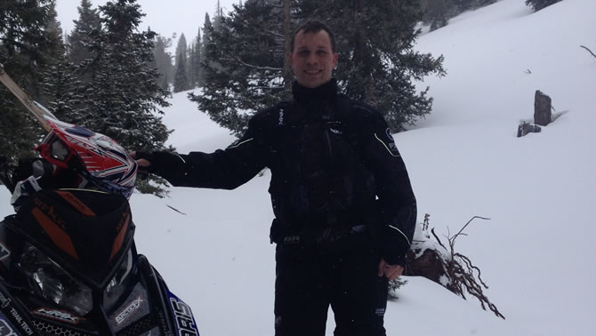 Picture of Scott Kuklock, standing by snowmobile.