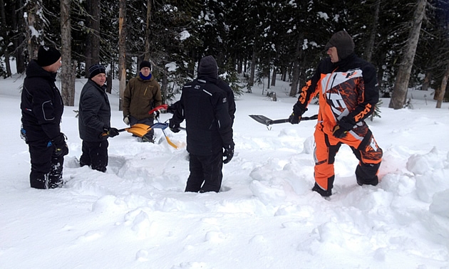 A group of avalanche trainees learning how to keep rescuers spaced out when shovelling. 