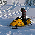 child riding a snowmobile