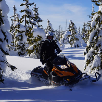 Picture of snowmobiler in deep powder. 