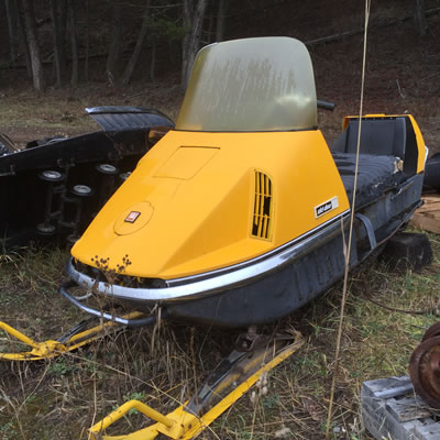 A bright yellow vintage Ski-Doo 399 Olympic Nordic. 