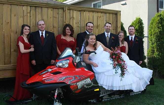 Bridal party gathered around a snowmobile