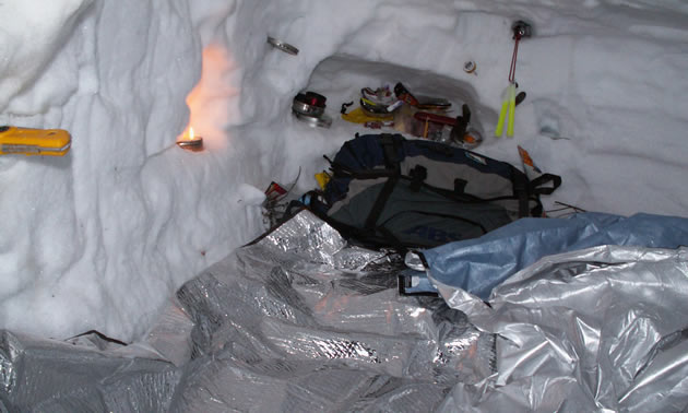 A backpack on a tarp in an igloo.