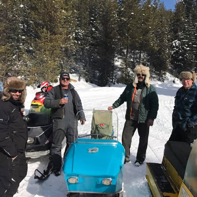 Ray Kelly (back right) and members of the Cranbrook Snowmobile Club proudly display the restored 1965 Snow King.