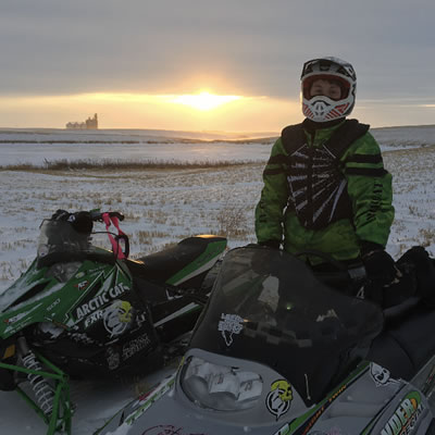 Erik Foster's son, Kaine, is wearing a chest protector and helmet. 