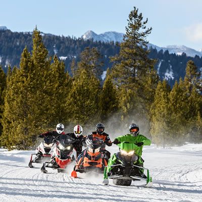 A group of snowmobilers out enjoying a ride.