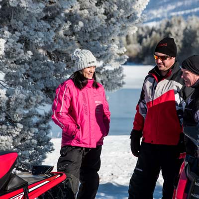 Group of snowmobilers talking to each other. 