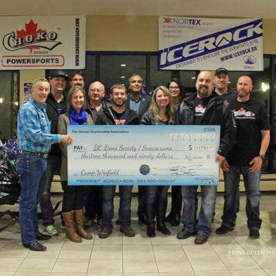 Organizers from the Vernon Snow Show hold up a large cheque for the Easter Seals Snowarama Kids campaign. 