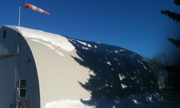 A Quonset hut with snow on it