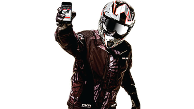 Picture of snowmobiler holding up a cell phone with the Snow Trails app on it. 