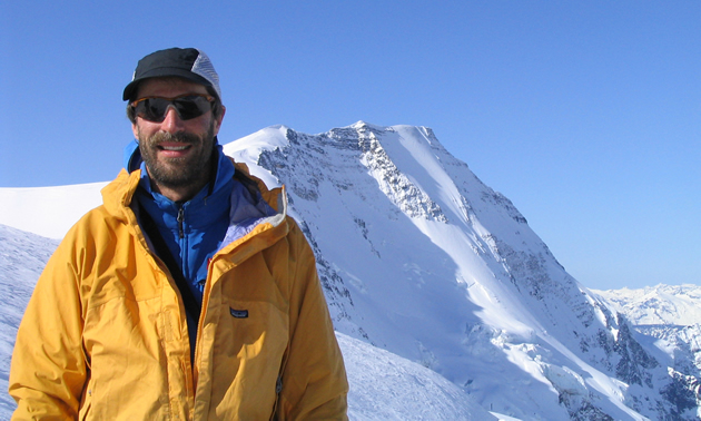 Man standing in a snowy area in the mountains
