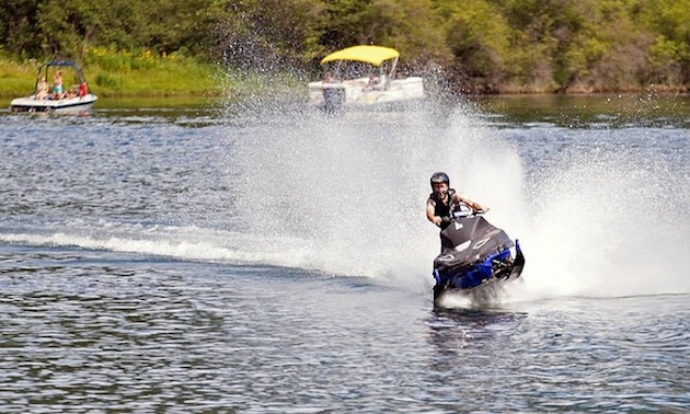 Taylor Fisk from MotoFist rides his sled across the water. 