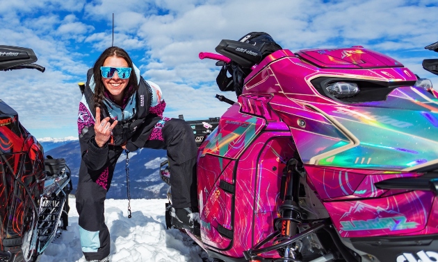 Taylor next to a pink snowmobile