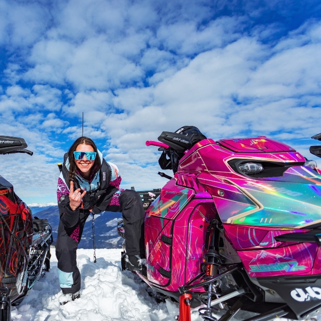 Taylor next to a pink snowmobile