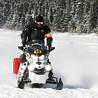 Two snowmobile racers neck and neck. 