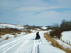 a sledder on a wide, flat trail