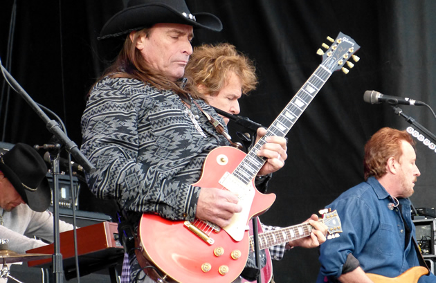 Lead guitarist for the Outlaws plays a riff at the snowmobile expo. 