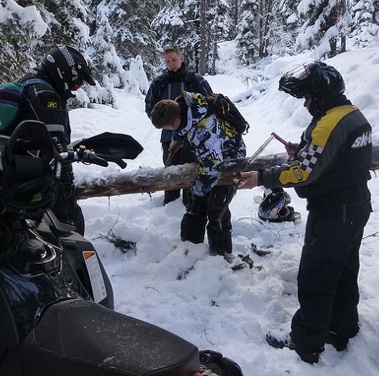 Members of the Timberline Cruisers working to clear off a trail. 