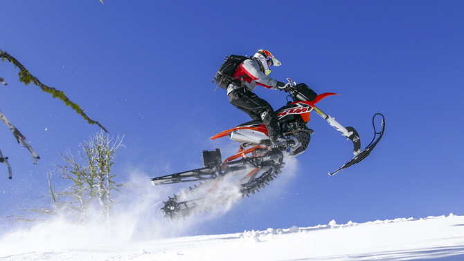 A picture of a rider Timbersledding, a combination of dirt-biking and snowmobiling. 