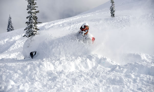 A snowmobiler slashes into the deep snow around Revelstoke. 