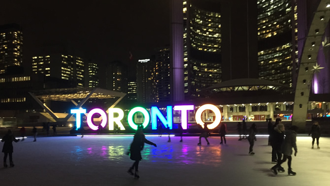 Skaters at an outdoor rink in Toronto in front of City Hall. 