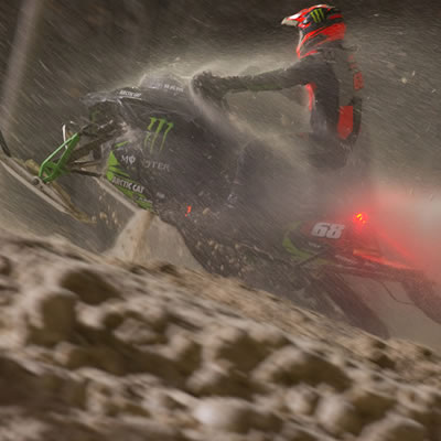 Tucker Hibbert on his snowmobile, night scene. 