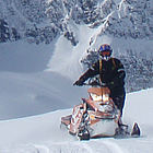 person on a sled in the mountains