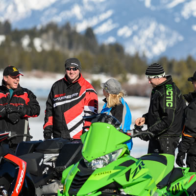 Group of snowmobilers getting ready to go out. 