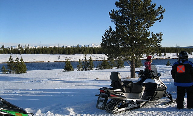 people snowmobiling in West Yellowstone, Montana