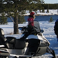 people snowmobiling in West Yellowstone, Montana