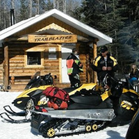 The local snowmobiling club keeps the trails in Whitecourt in great shape. Here, the Murphy family takes a break at the Carson cabin.

