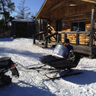 Mother and child in a snowmobile tobaggan