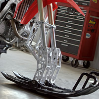 A Timbersled snow bike with a dual-ski suspension on the front. 